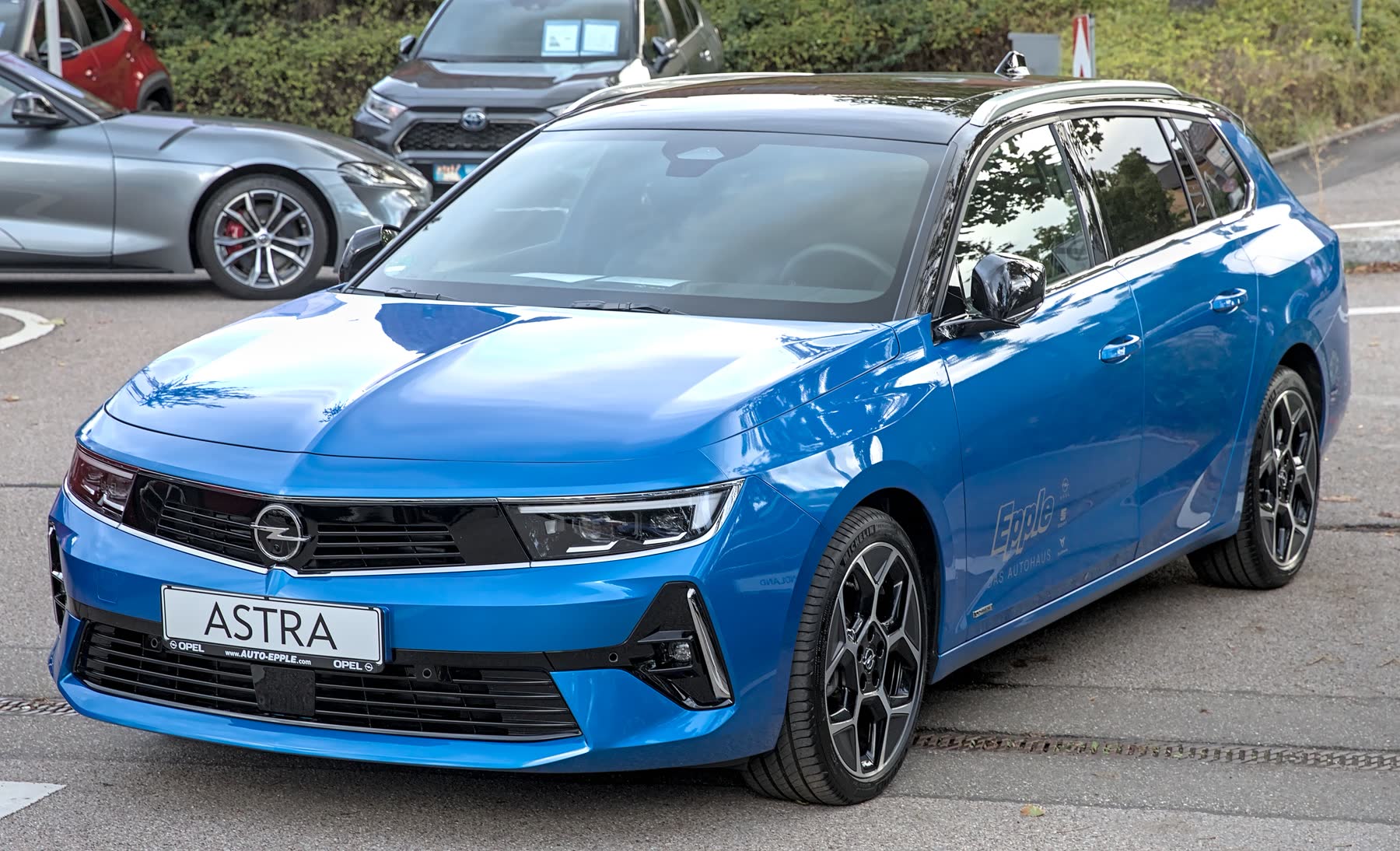 Blue estate car with black alloy wheels