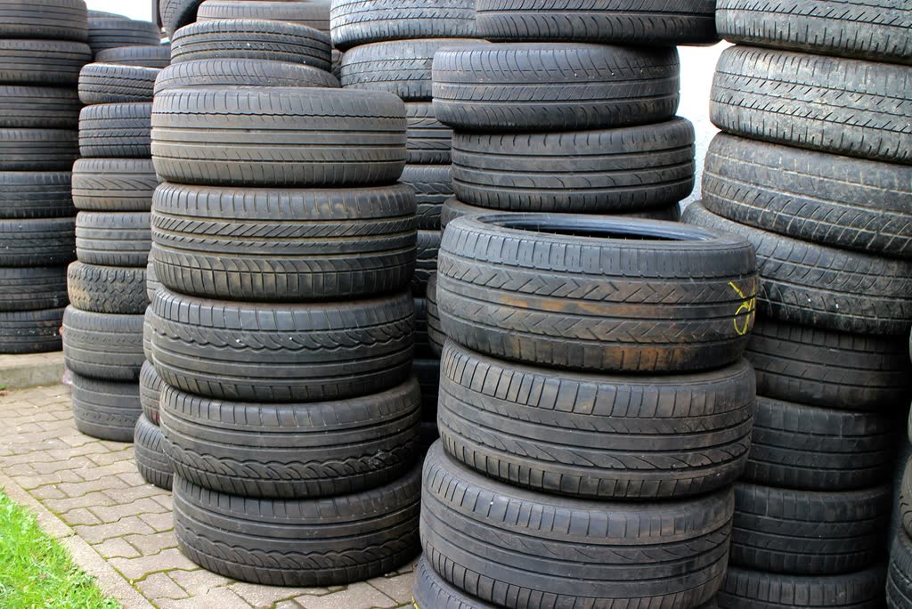 Stacks of used car tyres ready for sorting